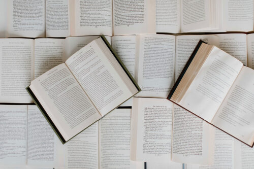 Opened Books Stacked on Top of Each Other