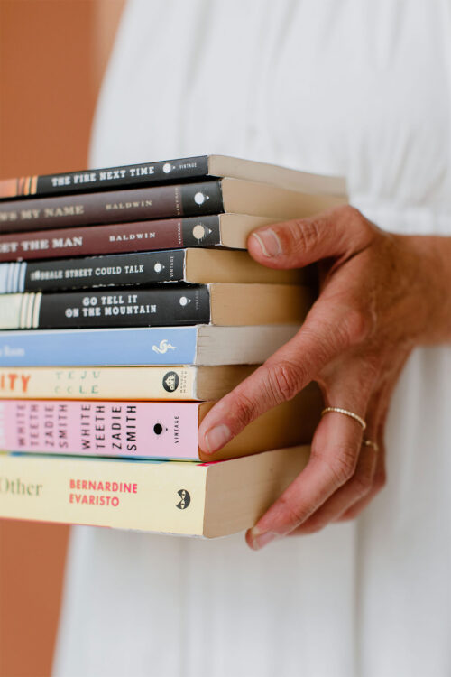 Consultant Holding a Stack of Books