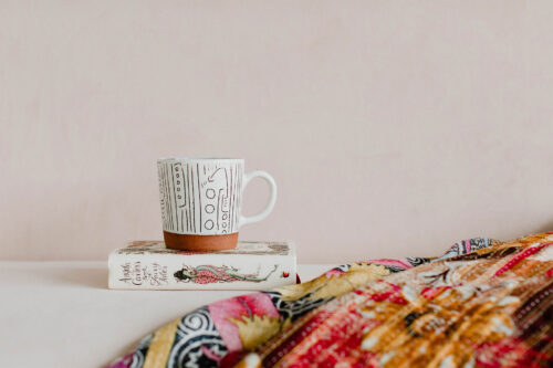 Cup of Coffee on a Book with Vibrant Cloth